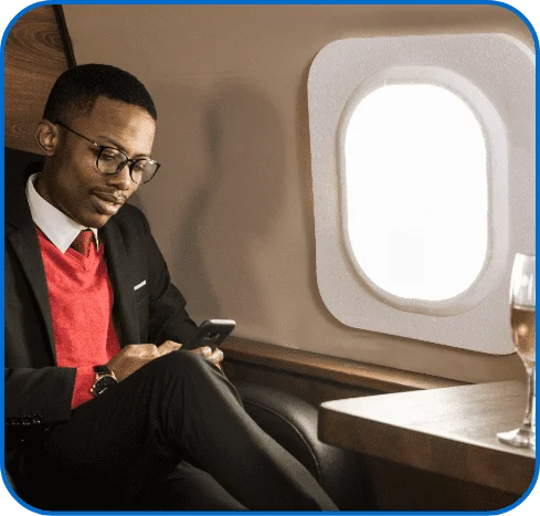 man using phone on plane